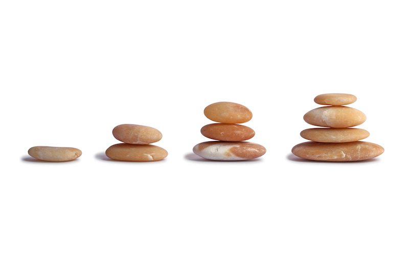 Stones stacked on white background, a symbol of growth, the concept of growth.